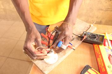 A person working with a voltmeter.