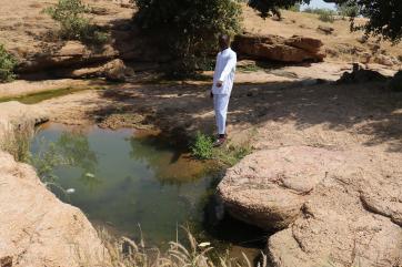 Person stands near a stream in nigeria