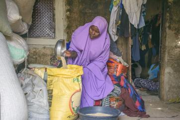 A person stores sesame seeds in a bag.