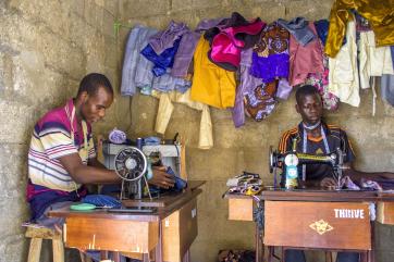 Two people working in their shop.