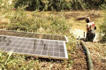 A person using a solar powered irrigation system.