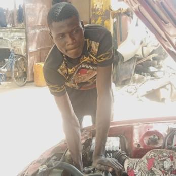 A person inspecting an automotive engine.