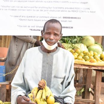 A person holding fruit.