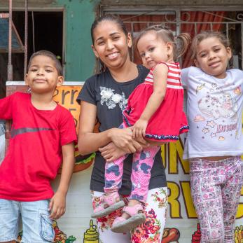 A person posing with their children.