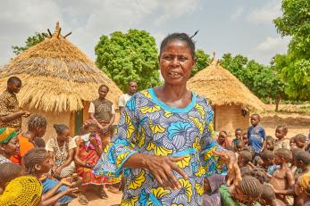 Nigerian woman amidst her community.