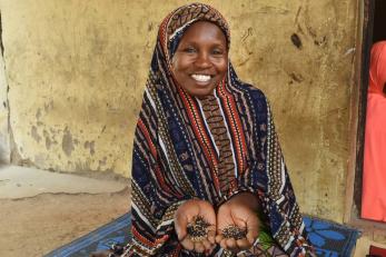 A person holding seeds.