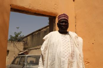 Abba butu in front of his home in maiduguri