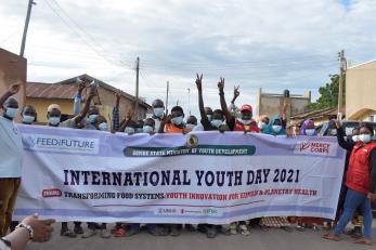 A group of people carrying a banner for international youth day 2021.