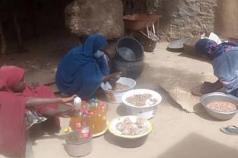 Nigerian women process their ground nut harvest.