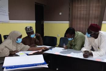 Participants design messaging for community sensitization at a training for trainers workshop.