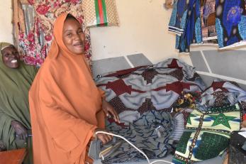 A person ironing a dress.