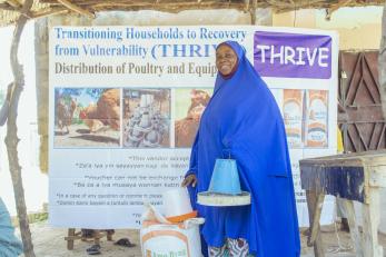 A person posing for a picture after redeeming their poultry startup items.