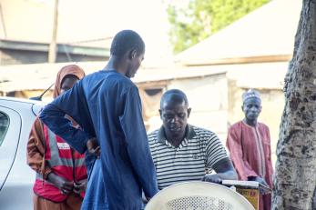 A person performing verification for a participant before redemption of food items.