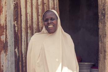 Karu bulama poses for a picture in front of her room.