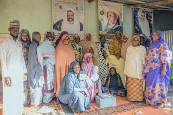 Members of the zumunci savings group alongside the village agent overseeing the affairs of the group alongside the mercy corps officer in charge of the program.