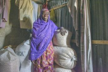 A person posing for a photo with their harvested produce.