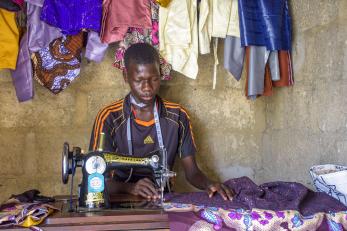 A person using a sewing machine to work with fabric.