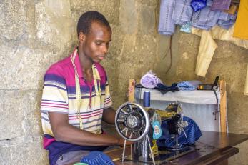 A person using a sewing machine to work with fabric.