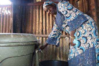 A person using a water valve.