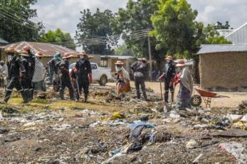 People clearing up a dumpsite.