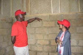 A person giving a tour of a new shelter.