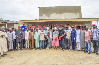 Group photograph of partners during the launch of the muna type transitional shelter.