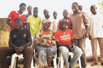 A collective of farmers pose together for a group photo.