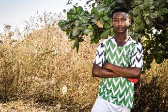 Man standing in agricultural setting.