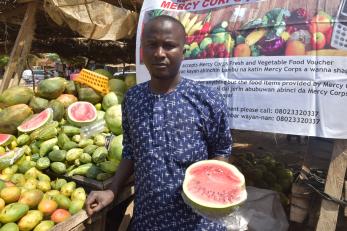 A person at a fruit stand. 