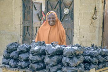 A person displaying charcoal for sale.