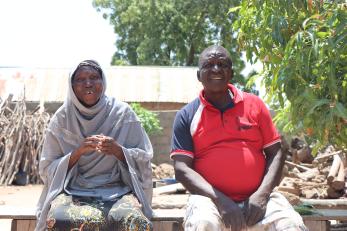 A farmer and their spouse sitting next to each other.