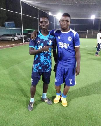 Two futbol players posing for a photo.