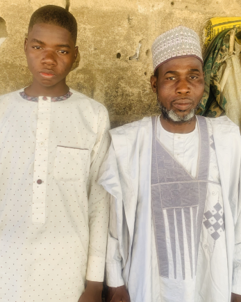 Musa akilu with adamu usman umaru, head teacher at the islamic school.