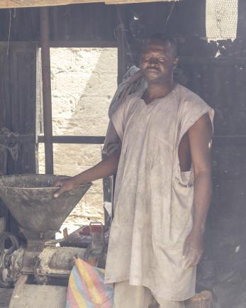 A grinder poses in his workshop.