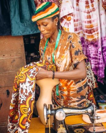 Oluwayemisi carefully crafting a headpiece, showcasing her skill and creativity.