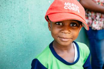 Child in Mercy Corps hat