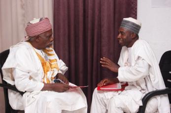 Two Nigerian men in conversation.