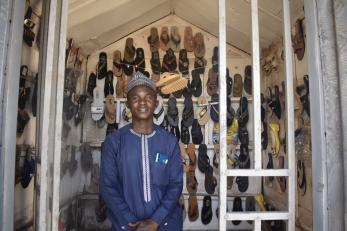 Safiya Adamu, President of Sangari Multipurpose Group, in the shoe shop he set up after collecting loan.