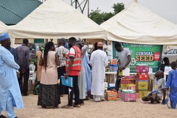 An agro-input fair with smallholder farmers and product sellers.