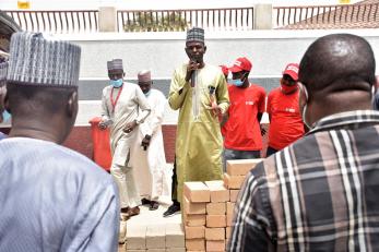 A person speaking to a crowd.