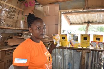 Magdalene Joseph in the kiosk where she sells solar products.