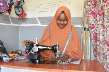 A person using a sewing machine.