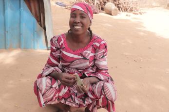 A person sitting and smiling for the camera.