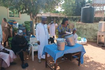 Program participants reviewing hygiene kits and 20 liter buckets distributed by Mercy Corps via health facilities to encourage communities without basic health supplies to follow hygiene guidelines.