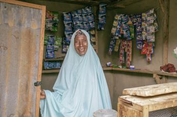 Amina Inuwa happily posed for a picture inside her provision store.