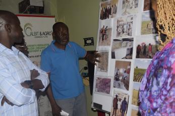 Dr. Yusuf Yakaubu Yer Ballahhe, showcasing pictures of his company’s activities in the Northeast to USAID during the USAID field visits in Adamawa state.