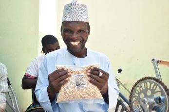 A person displaying a pack of cowpea processed by the Gamayya Disabled Group.