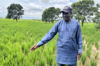 Nigerian farmer standing in his field.