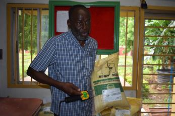 Dr. Yusuf shows us the bags of climate-resilient seeds that Albit has grown and provided to farmers.