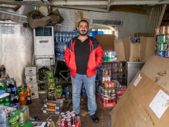 Man standing in front of emergency cache supplies.